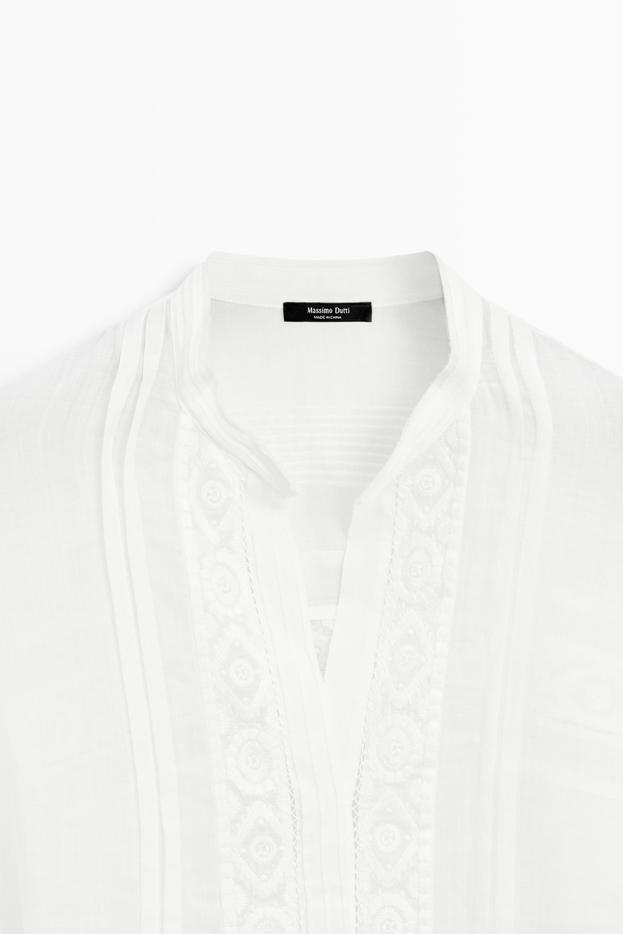 Stand collar blouse with embroidery and ruffles